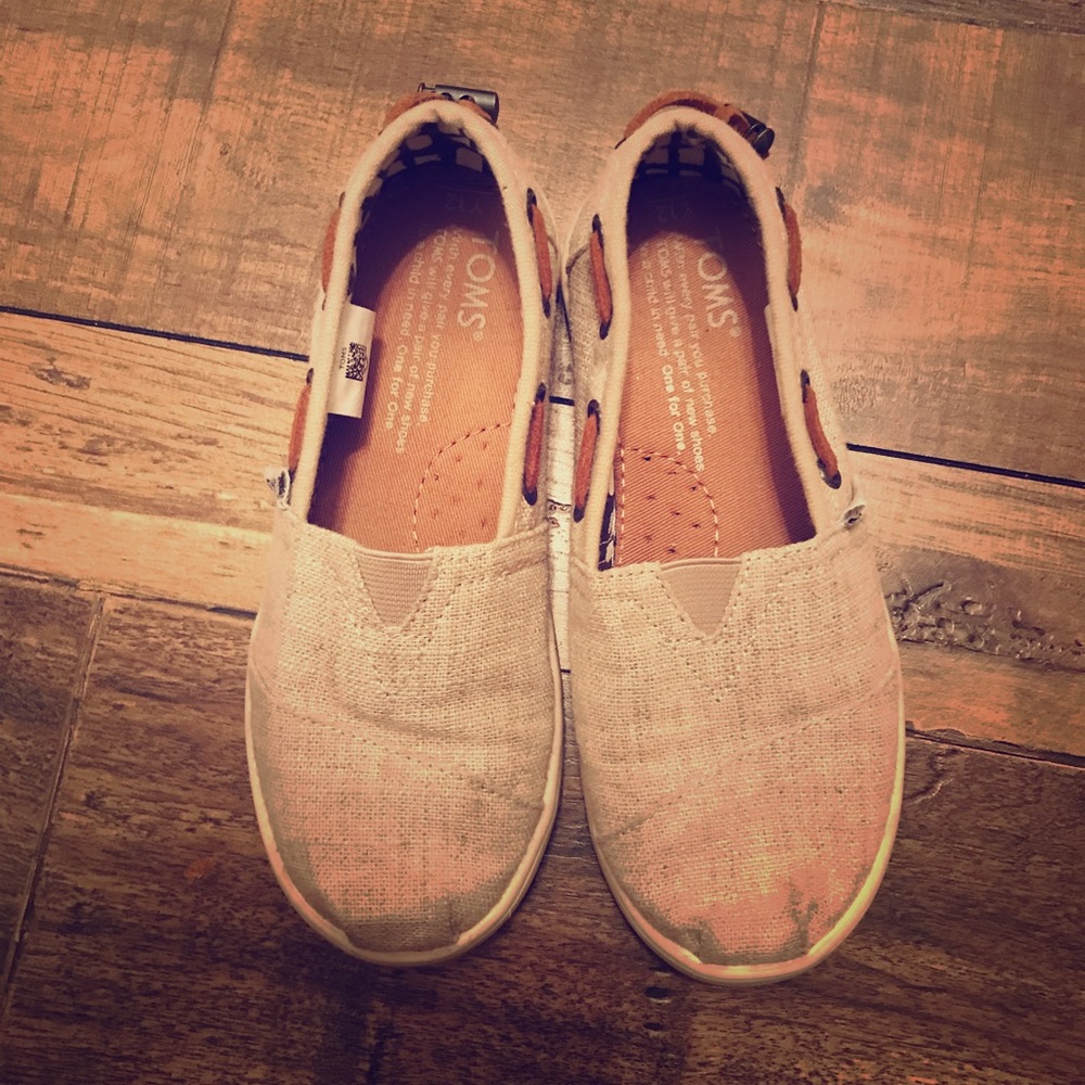 Tom’s size 12 girls slip on canvas tan exterior